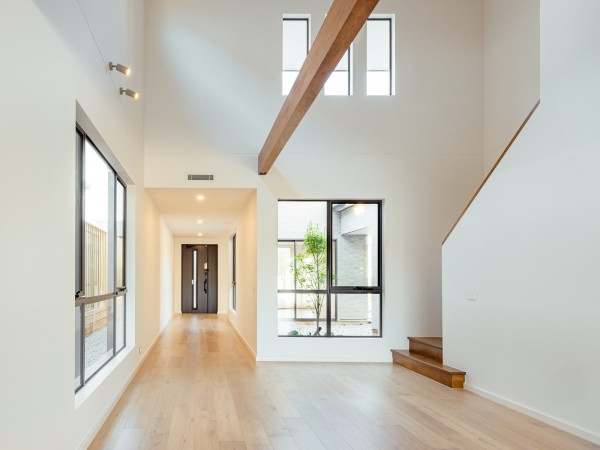 Entrance area to a five bedroom, two storey SHAWOOD home at Norman Estates featuring SHAWOOD signatures; high ceilings, exposed timber beam and SHAWOOD door.